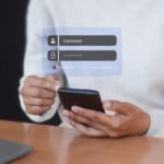 Person holding smartphone with floating digital login interface showing username and password fields, Remember Me checkbox, and Forgot Password link