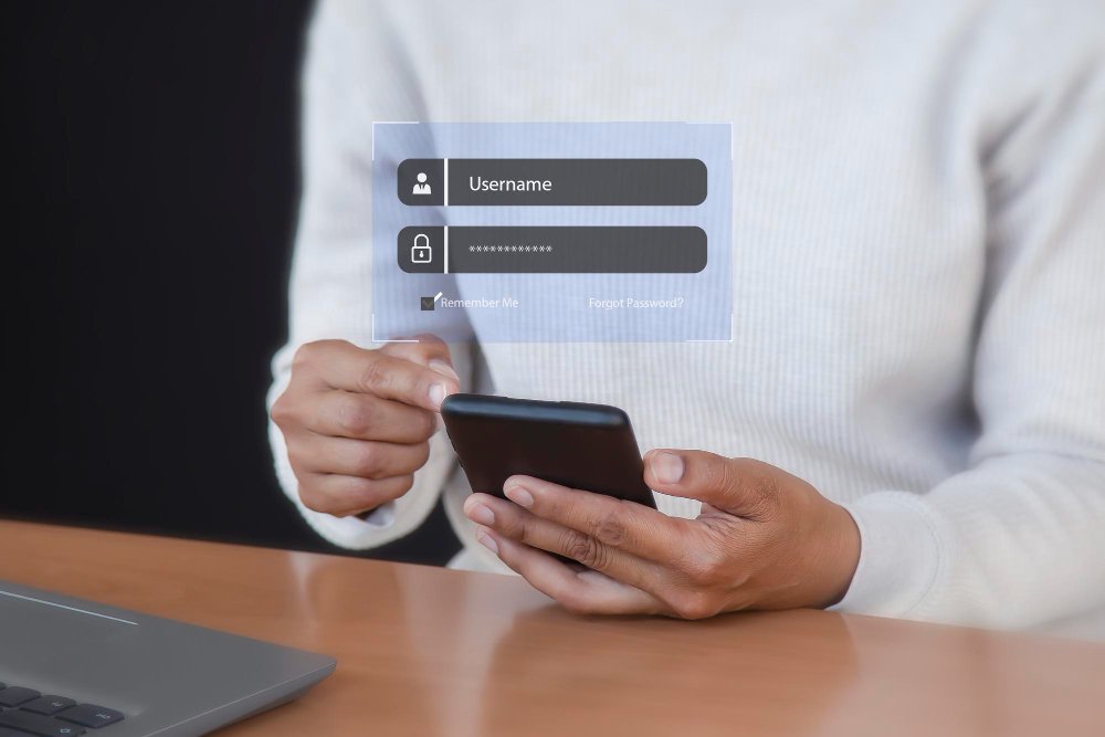 Person holding smartphone with floating digital login interface showing username and password fields, Remember Me checkbox, and Forgot Password link